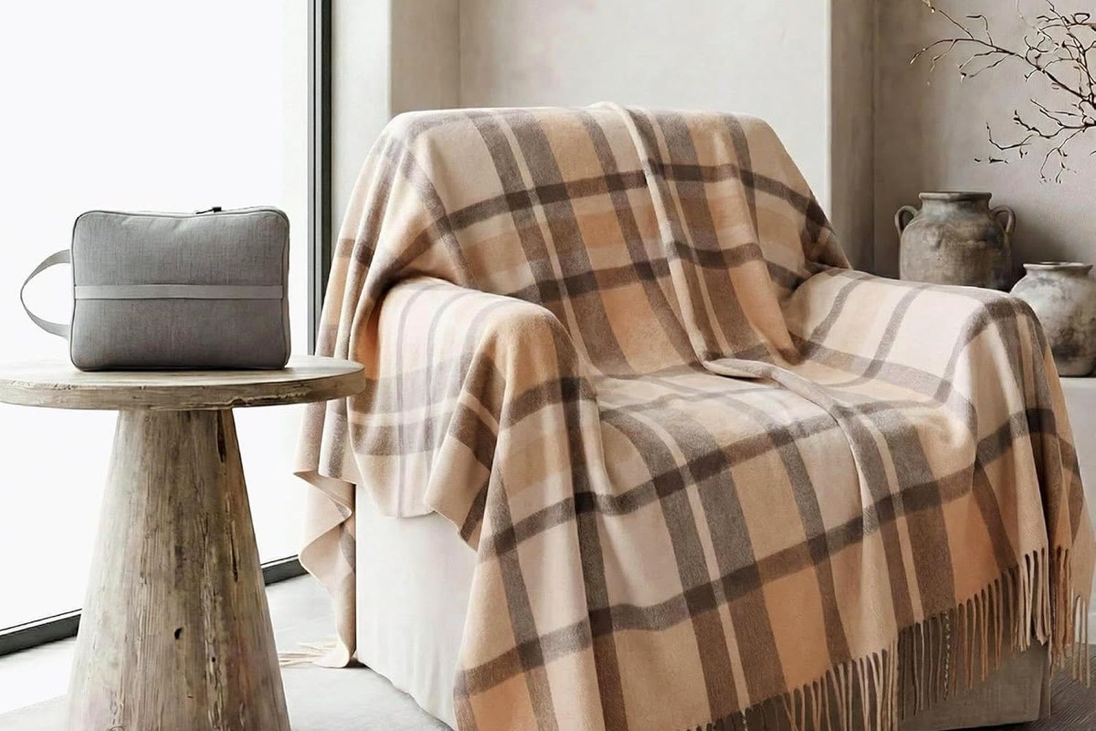 Wool plaid throw blanket with fringed edge, styled over a chair